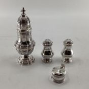 A pair of sterling silver pepperettes, a small mustard and a German white metal sugar shaker