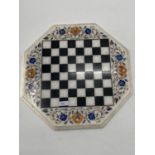 A Hexagonal hardstone chess board with inlaid coloured hardstone decoration, 43 x 43