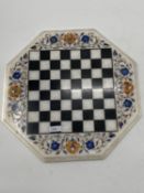 A Hexagonal hardstone chess board with inlaid coloured hardstone decoration, 43 x 43