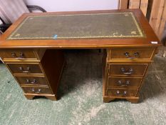 A reproduction C20th stained pine knee hole 8 drawer desk 123W x 60D x 77cmH