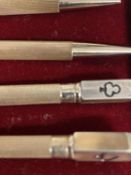 A set of Sterling silver bridge pencils in box together a further silver pencil and a yellow metal