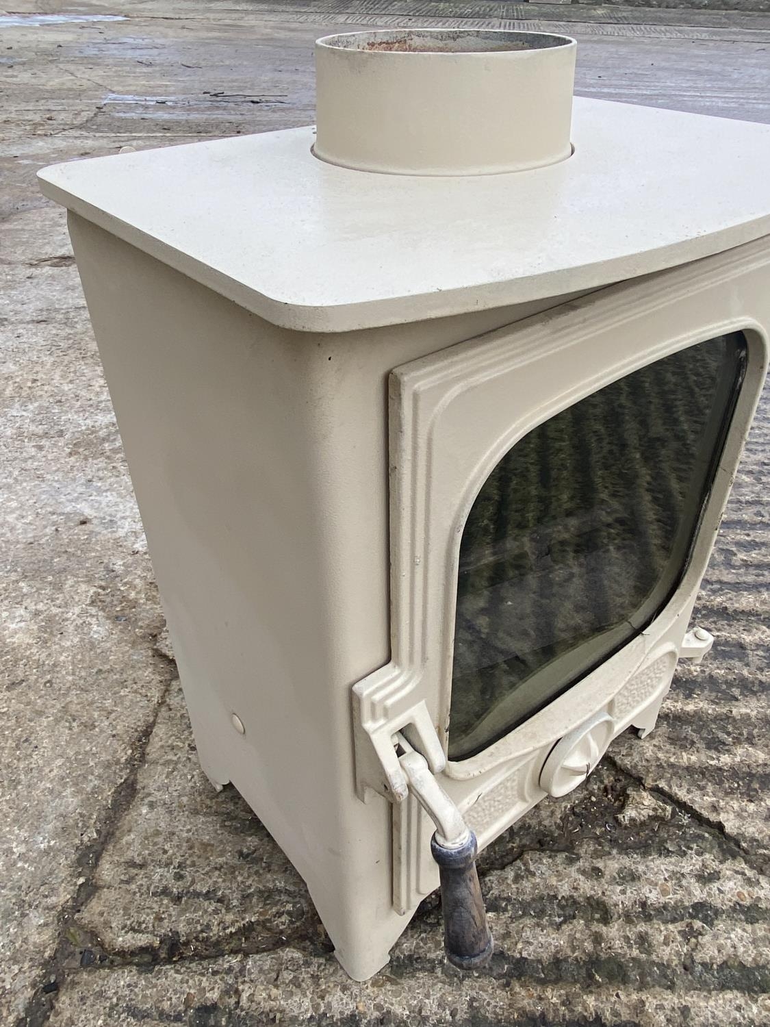 A wood burner, "Country 4" by Charnwood, cream, with single door. Purchased new in 2016 and was in