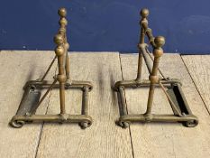 A pair of brass, Arts & Crafts style geometric shaped fire dogs, 26cmH