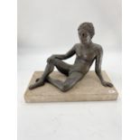 A bronzed effect reclining nude gentleman on a rectangular marble base, 50 x 24 x38cm