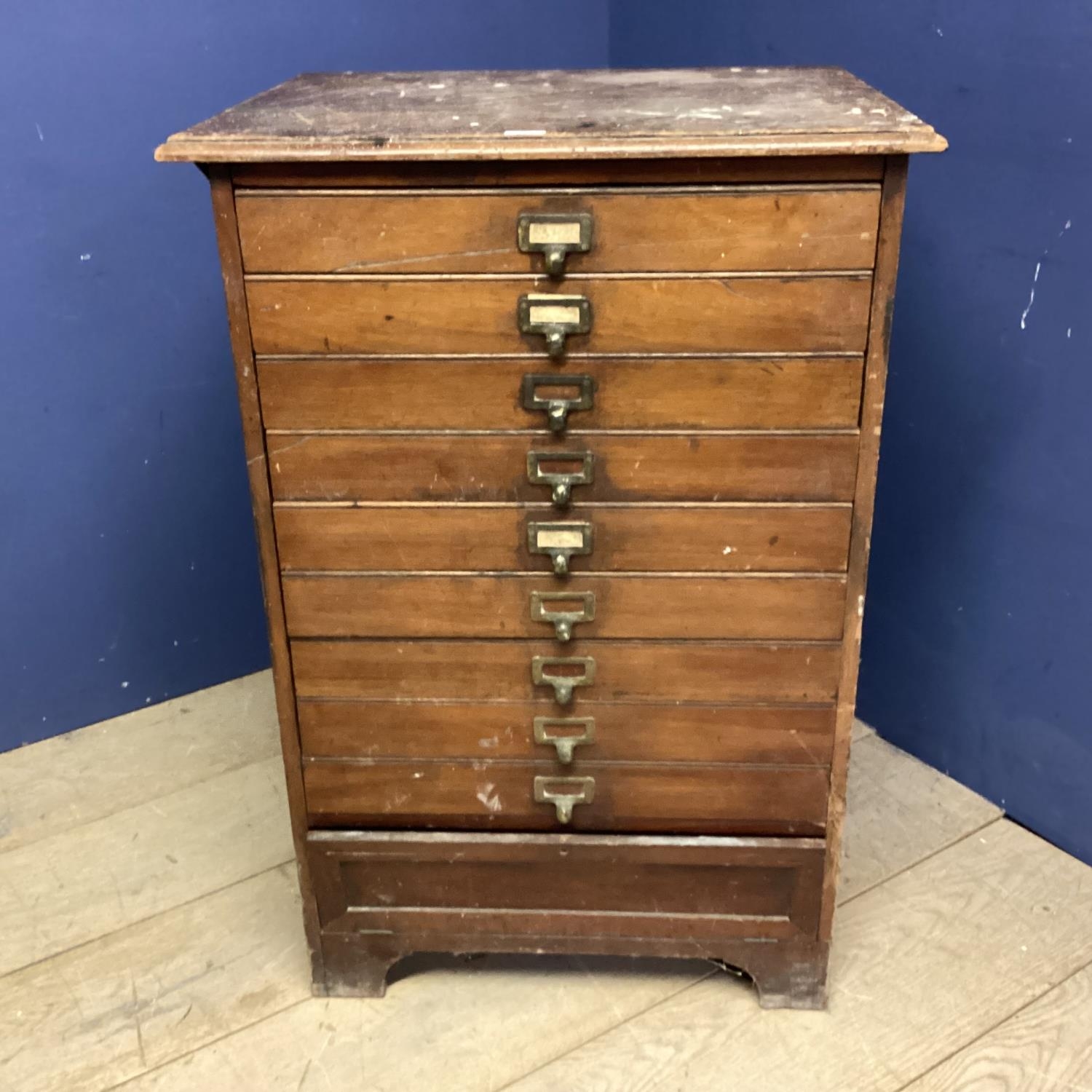 A Vintage narrow filing chest of 9 drawers, bearing label to bottom section: Percy Jones Ltd,