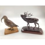 A modern decorative bronze style model of a red stag, mounted on wooden plinth, 27cm H x 30cm W