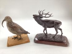 A modern decorative bronze style model of a red stag, mounted on wooden plinth, 27cm H x 30cm W