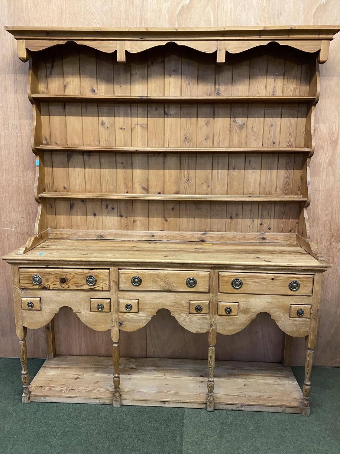 A large pine dresser, the base with 3 drawers and 6 small spice drawers, above a shaped frieze,