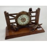 A desk clock, depicting model of Fox and Hounds, 28cm Wide, on a wooden plynth