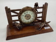 A desk clock, depicting model of Fox and Hounds, 28cm Wide, on a wooden plynth