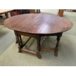 A large heavy oak fall flap dining table , 173cm both flaps extended x 141cm wide