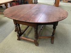 A large heavy oak fall flap dining table , 173cm both flaps extended x 141cm wide