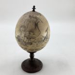 An Ostrich egg on cast bronzed mounts and nautical scene 23cmH