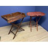 A mahogany and brass hinged folding butlers tray on a folding stand; and a worn red lacquered shaped