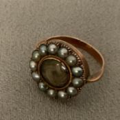 A C19th 9ct gold mourning ring, central quartz panel with a surround of split pearls, 3.8g