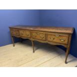 A good oak dresser base, with four drawers and brass handles, 216 x 51cm, some wear and old splits