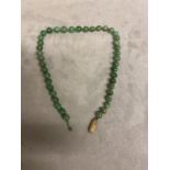 A graduated jade bead necklace on a 9ct gold clasp, 39cm, Largest bead approx 9mm, 33.3g