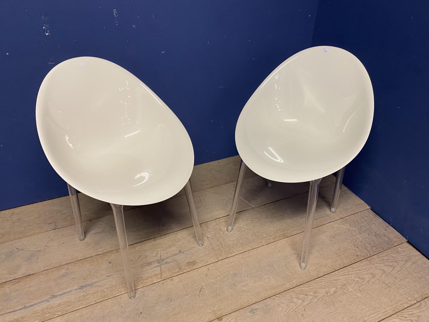 Pair of modern designer style , white and transparent plastic tub chairs, stamped Kartell to plastic