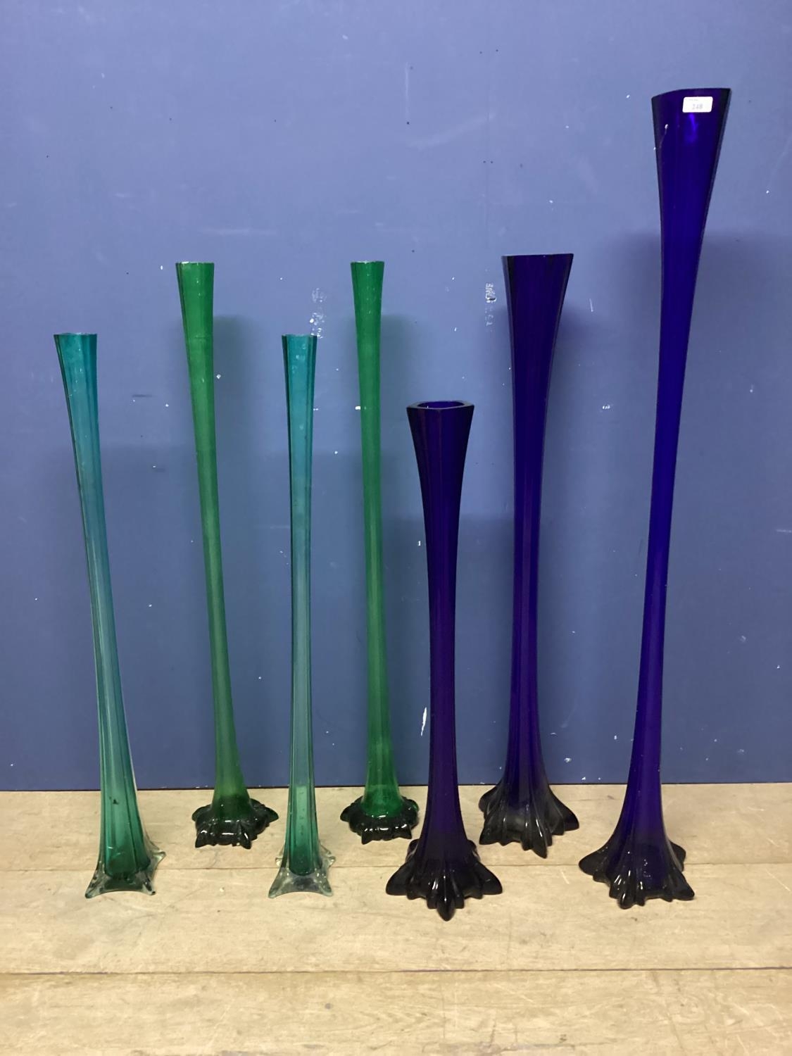 Seven tall narrow decorative glass flutes (were previously used by wedding flowers co) tallest 121cm