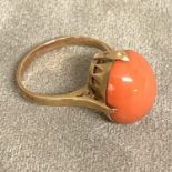 A 9ct gold ring set with red cabochon coral, 4.2g, size N