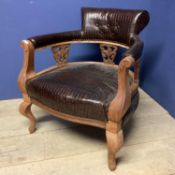 An early C20th walnut tub chair with faux crocodile skin upholstery, 74cmH