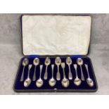 A boxed set of 12 Sterling silver tea spoons, 290g, various date/makers