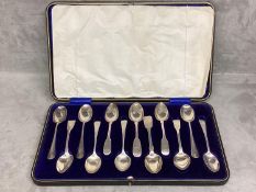 A boxed set of 12 Sterling silver tea spoons, 290g, various date/makers