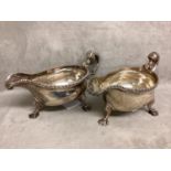 A pair of Georgian Sterling silver sauce boats, beaded rim, scroll handles raised on three feet,