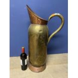 A very large Victorian copper and brass jug riveted body with loop handle 75cmH