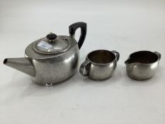 An Arts and Crafts style Tudric three piece tea set