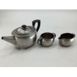 An Arts and Crafts style Tudric three piece tea set