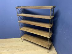 A Maison Jansen style five tiered bookcase, with a brass galleried top, and X sides and column