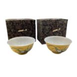 A pair commemorative Chinese porcelain tea bowls yellow ground in fitted boxes, in China three