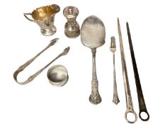 A collection of sterling silver items to include Georgian letter openers, pepperette, cream jug,