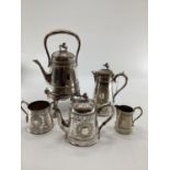 A silver plated five piece tea set with ornate decoration, Bacchus mask spouts engraved to jugs with