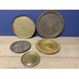 Five metalwares platters, some embossed and carved to centre and rim