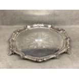 NOTE THIS WEIGHS 910 GRAMS A sterling silver circular tray with cast border, chased decoration on