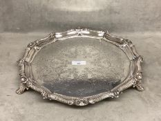 NOTE THIS WEIGHS 910 GRAMS A sterling silver circular tray with cast border, chased decoration on