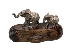 PATRICK MAVROS, a silver and hardwood figure group, modelled as two elephants (damage to tusks) on a