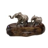 PATRICK MAVROS, a silver and hardwood figure group, modelled as two elephants (damage to tusks) on a