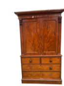 Large Victorian flame mahogany two door wardrobe, with inset slides, and two short above two