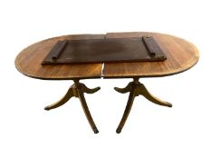 A modern reproduction twin pedestal dining table, with extra leaf, as found
