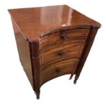 A large Regency mahogany inverted bow front commode with reeded columns and turned raised legs to