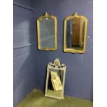 Pair of gilt framed wall mirrors with scrolling borders and finial, and another mirror with grey