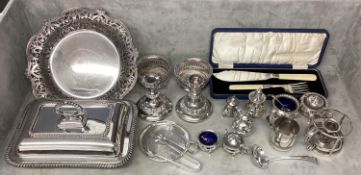 A collection of silver plated items, candlesticks, pierced dish etc