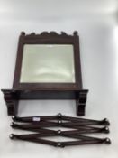 An oak mirror, bevelled plate wish shelf below, and a consetina wall hanging rack or coat hooks