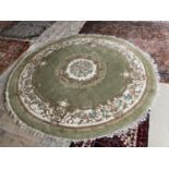 Large Chinese style green ground rug 275cm diameter, a pair of pink rugs 180cm x 120cm, pair of blue