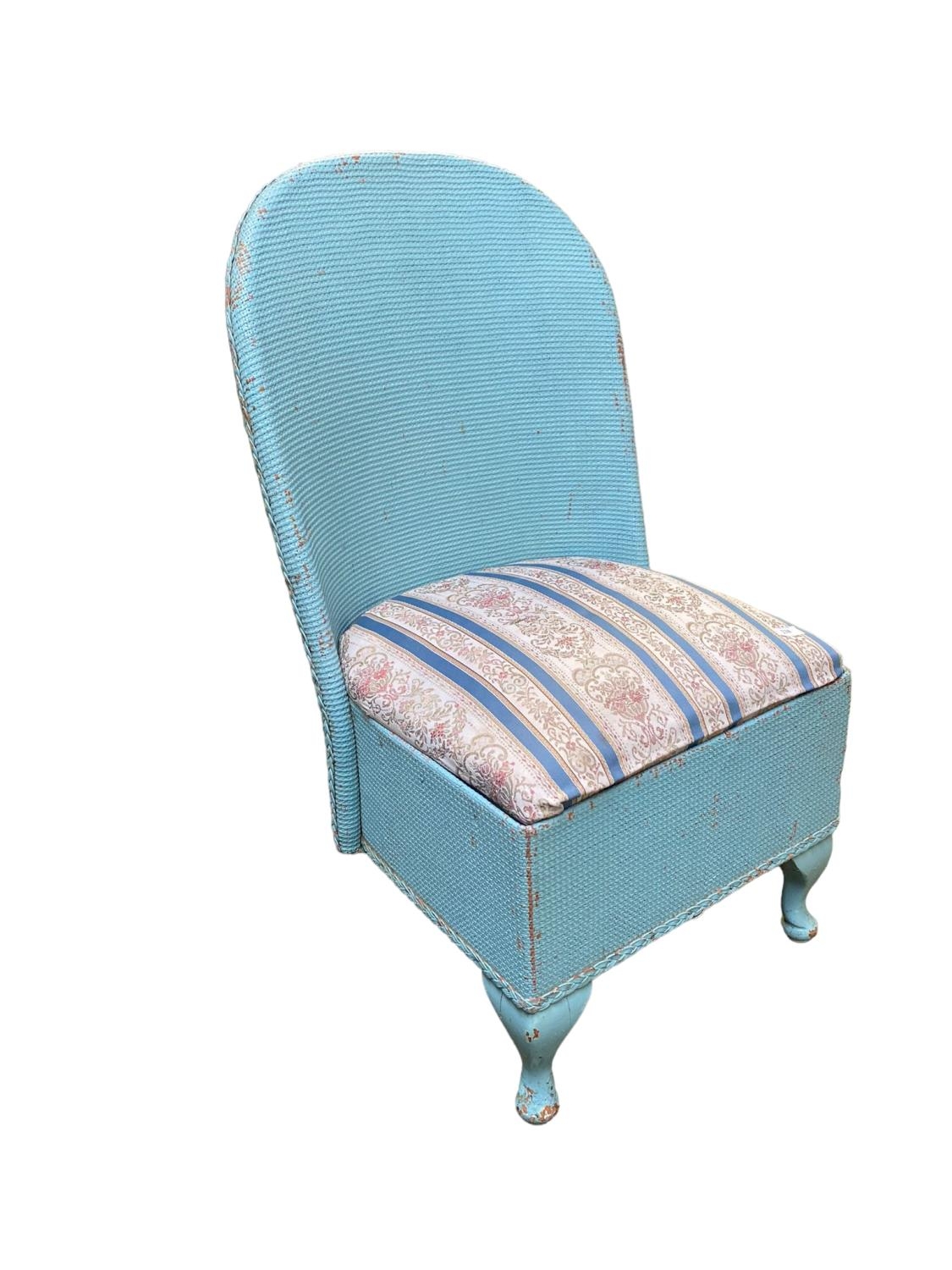 A blue painted old wicker Lloyd Loom style bathroom chair, as found with wear