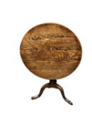 An oak tilt top circular snap top pedestal occasional table, with wear 75cm dia x 68cm H