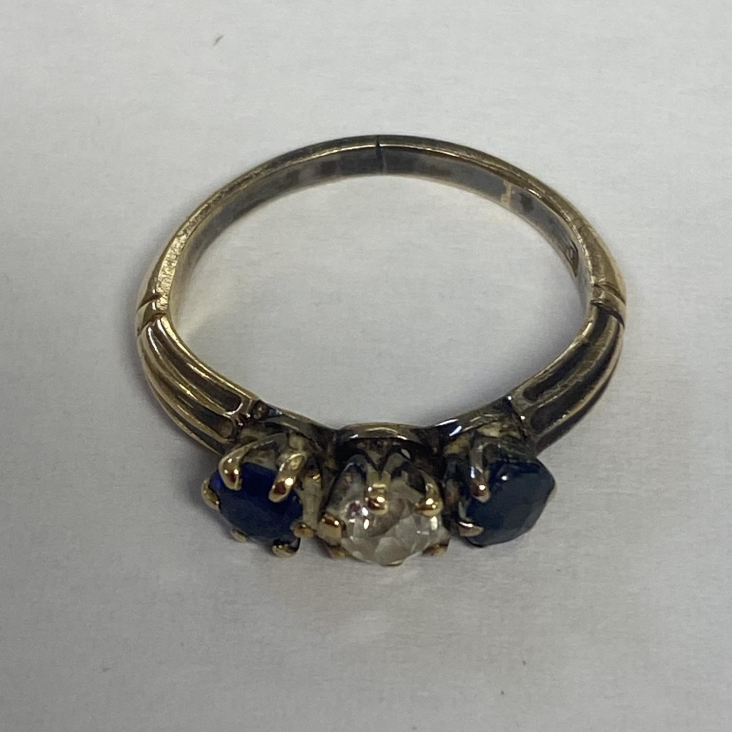 A sapphire and diamond ring in unmarked yellow metal central old diamond, with round cut sapphire - Image 2 of 5